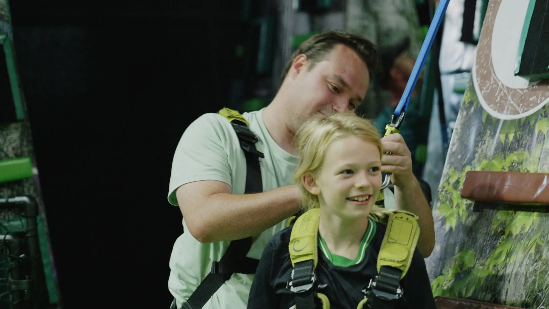 A child being fitted with a climbing harness at Gigi's Klim World